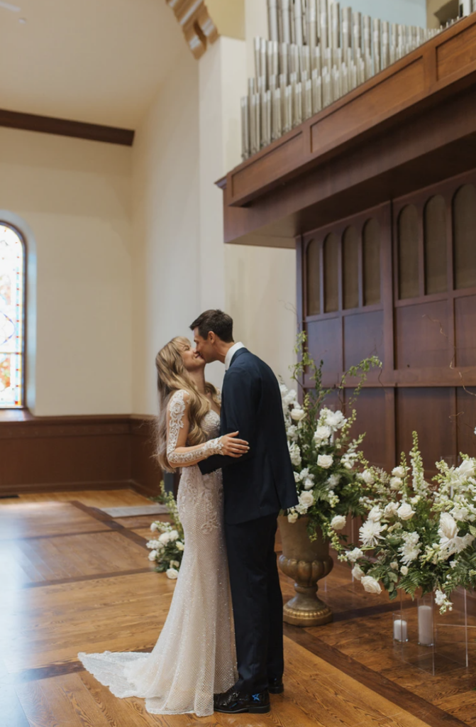 A bride and groom share a kiss at their ceremony in The Cappella Ballroom.